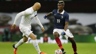 France"s Paul Pogba, right, is challenged by England's Jonjo Shelvey during the international friendly soccer match between England and France