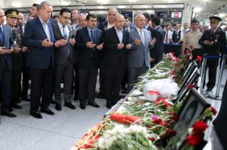 Turkish President Recep Tayyip Erdogan (left) praying at Ataturk airport, 2 July 16