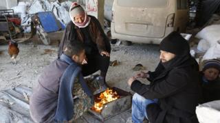 People in Aleppo around a fire at Jibreen shelter centre on 1 February 2017