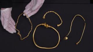 Three gold necklaces and bracelet