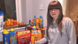 Photo of Yvette with bottles of Lucozade