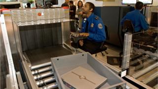 A Transportation Security Administration (TSA) officer reads the X-ray of a laptop computer at Baltimore-Washington International Airport.