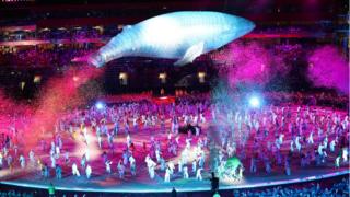 A model of Migaloo, the famous albino humpback whale, appears to jump over all the performers in the final piece of the ceremony.
