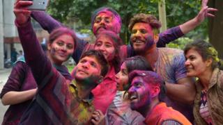 Friends taking pictures after Holi