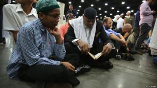 Muslim worshippers read from the Quran at the prayer service in Louisville