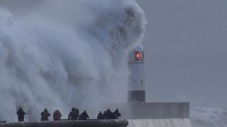 waves crash against a sea wall in Aberystwyth