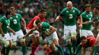 Ireland's Jonny Sexton tackled by Wales' Rhys Webb during the World Cup Warm Up Match