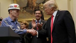 A coal miner worker shakes hands with President Donald Trump (16 February 2017)