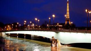 The Eiffel Tower with raised water levels at the Zouave statue of the Pont d'Alma bridge