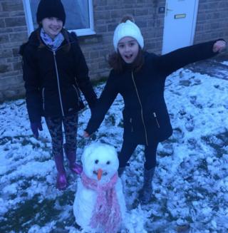 Two girls and their snowman