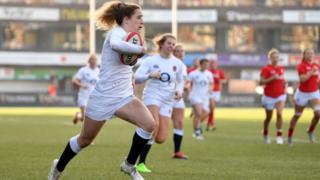Abby Dow of England breaks before scoring a try during the Wales Women and England Women match in the Women's Six Nations at Cardiff Arms Park on February 24, 2019 in Cardiff, Wales.
