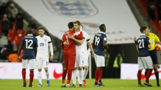 France captain and goalkeeper Hugo Lloris and England's Eric Dier hug each other at the end of the international friendly