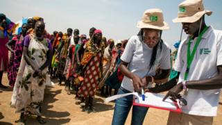 Two members of the German NGO Welthungerhilfe (WHH) register the beneficiaries of a food distribution on March 4, 2017, in a stabilisation center in Ganyiel, Panyijiar county, in South Sudan.