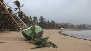 A yacht is stranded on the sand at Airlie Beach, in Queensland's Whitsunday region