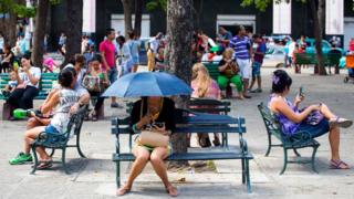 People surf the Internet at a Wi-Fi hotspot in Havana