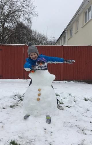 Image of a child with a snowman
