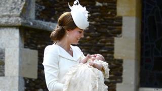 Catherine, the Duchess of Cambridge carries Princess Charlotte