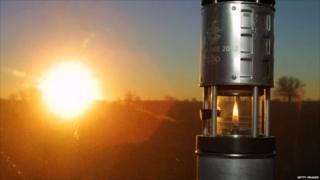 The Olympic flame is transported in the Olympic lantern at sunrise during the 2002 Salt Lake Olympic torch relay in Wichita, Kansas