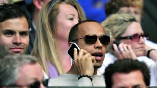 Lewis Hamilton on his mobile phone
