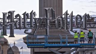 Builders put up the Harry Potter sign at Nelson's Column in London