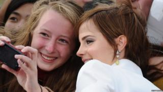 Emma Watson poses with a fan