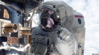 Mike Fossum carries out a space walk at the ISS