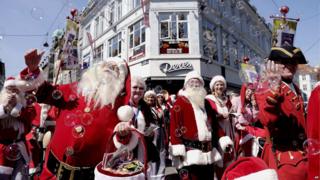 Santas in a street parade during the World Santa Claus Congress in Denmark