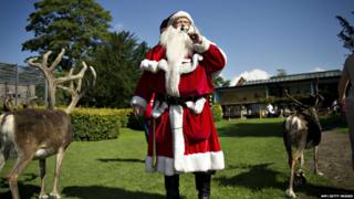 Santa with reindeers in Copenhagen Zoo during the World Santa Claus Congress