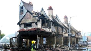 The burnt out shell of a furniture store in Croydon, south London