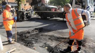 Workers clear up in Ealing High Street, west London