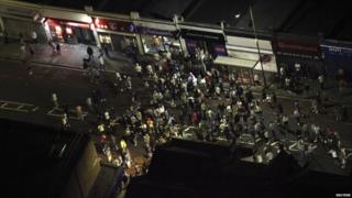 People gather on a street in Eltham, south-east London