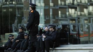 Policemen relax as they rest on a side street in Wandsworth, south London