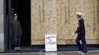 A sign outside a looted shop in Manchester