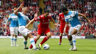 Liverpool's Stewart Downing is challenged by Sunderland's Lee Cattermole and Ahmed Elmohamady during the Barclays Premier League match at Anfield, Liverpool