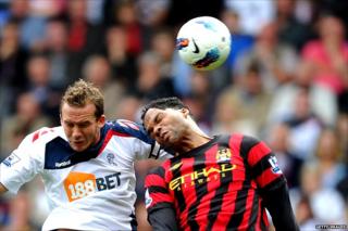 Kevin Davies challenges Joleon Lescott for a header