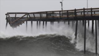 Waves break along the damaged pier in Ocean City, Maryland, on 28 August 2011