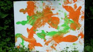 One of N'Dowe the lowland gorilla's paintings with green and purple paint.