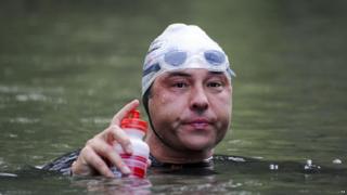 David Walliams takes a break on his Sport Relief swim down the Thames.