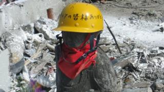 A Jizo statue wearing a safety helmet in Onagawa in Japan.