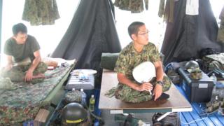 Self defence troops sitting on their beds in Onagawa, Japan.