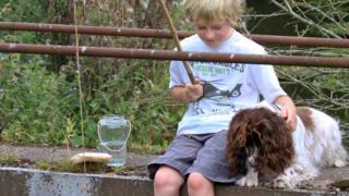 Meg the dog with a young boy fishing