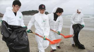 People trying to clean up the beach