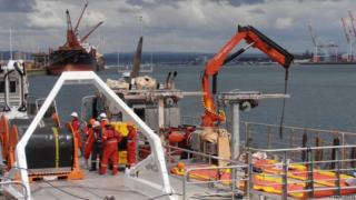 Ships preparing to take equipment to the cargo ship Rena.