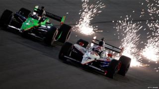 Dan Wheldon's car and sparks on the track