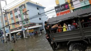 Truck carrying people away from floods