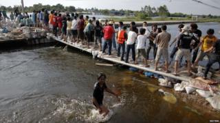 People carrying sandbags