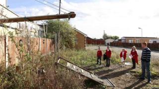 School kids waiting to climb up a makeshift ramp