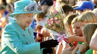 Queen given flowers by children