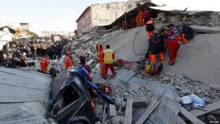 Rescue workers use special equipment to dig in the rubble