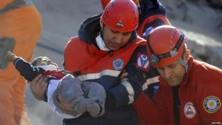 Rescued boy being carried by emergency worker